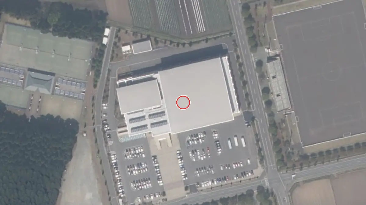 上空から見た三沢市国際交流スポーツセンター（中心の赤い輪が会場の位置）